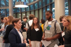 Students networking with entrepreneur